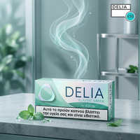 Box of Delia Classic Green dental floss on a marble surface with a blurred background